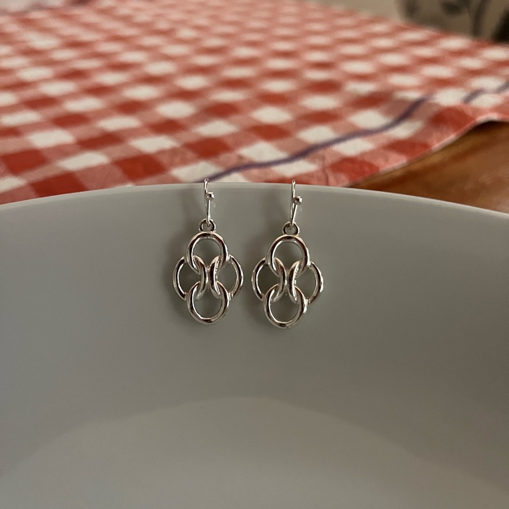 dangly silver tone love knot twisted earrings
